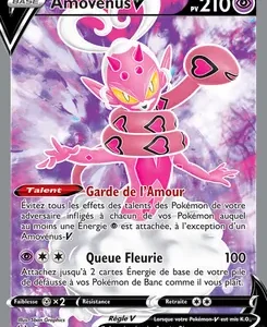 French Pokémon V card: Amovénus V, pink heart-themed Pokémon with yellow eyes, HP 210, two attacks ('Garde de l'Amour' and 'Queue Fleurie'), set against a purple-pink aura.
