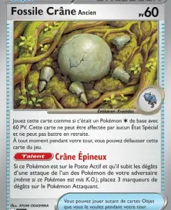 Carte Objet Dresseur: Fossile Crâne Ancien — peut être jouée comme une carte de base avec 60 PV; image d’un œuf fossile posé parmi des broussailles et pierres.