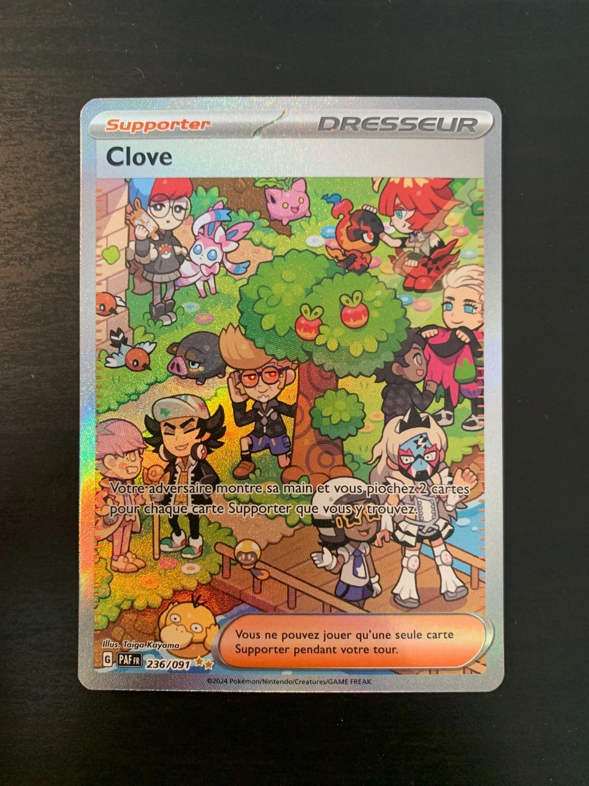 Pokémon card front titled 'Clove' with a colorful garden scene and holographic border, showing multiple characters and creatures.