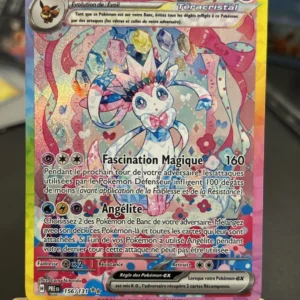 Nymphali EX Pokémon card with 270 HP, showing a pastel, holographic Sylveon and rainbow background; attacks include Fascination Magique and Angélite.